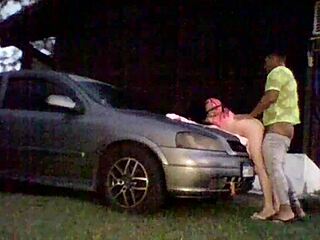 Amateur couple tries out shock absorbers on car's hood